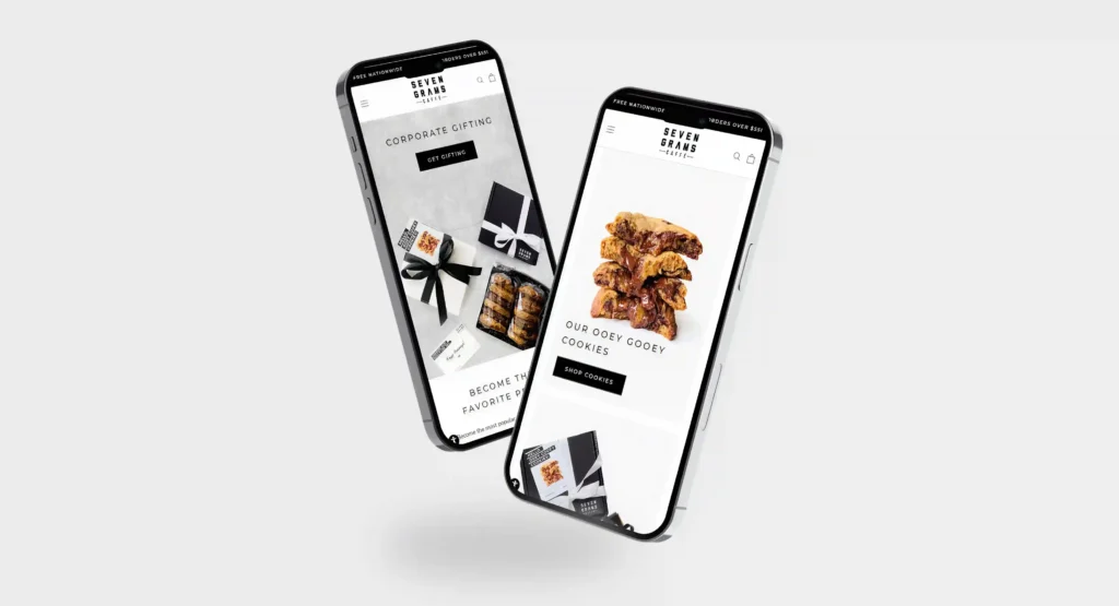 Two floating smartphones displaying the Seven Grams Caffé mobile website, featuring gourmet cookies and corporate gifting products on a clean light gray background.